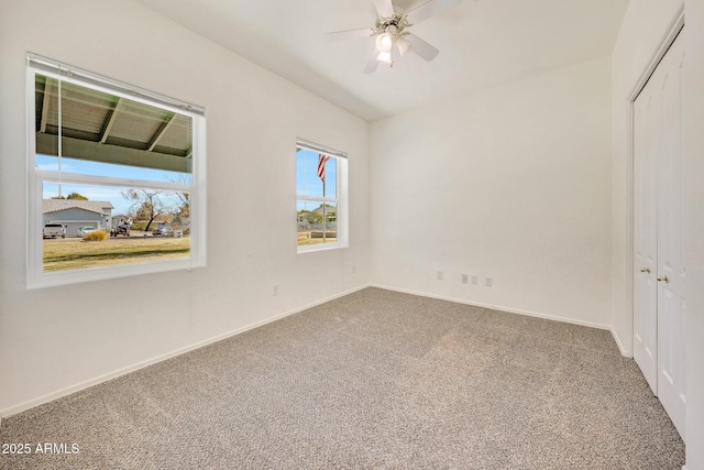 carpeted empty room with vaulted ceiling and ceiling fan