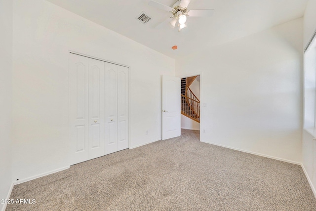 unfurnished bedroom featuring a closet, ceiling fan, and carpet