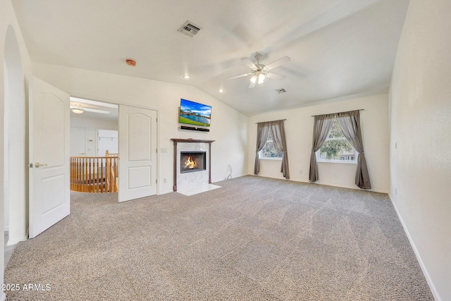 unfurnished living room featuring ceiling fan, carpet flooring, lofted ceiling, and a fireplace