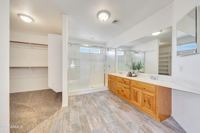 bathroom with an enclosed shower and vanity