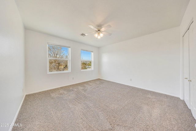 unfurnished room with carpet flooring and ceiling fan