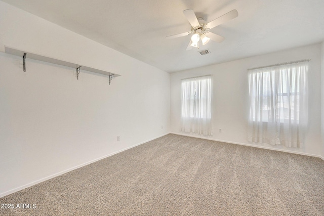 spare room featuring ceiling fan and carpet floors