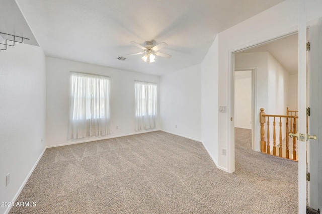 carpeted empty room featuring ceiling fan