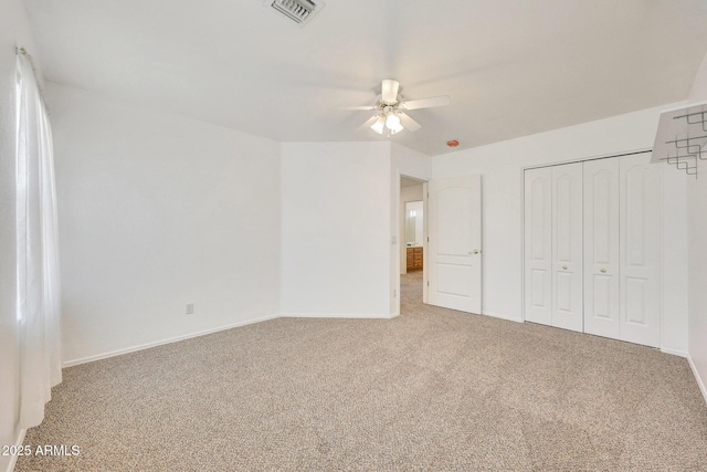 unfurnished bedroom featuring ceiling fan, a closet, and carpet