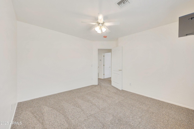 spare room featuring light carpet and ceiling fan