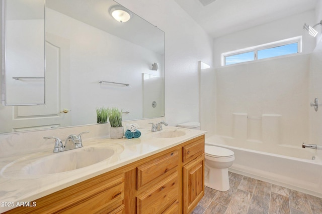 full bathroom with vanity, hardwood / wood-style floors, shower / tub combination, and toilet