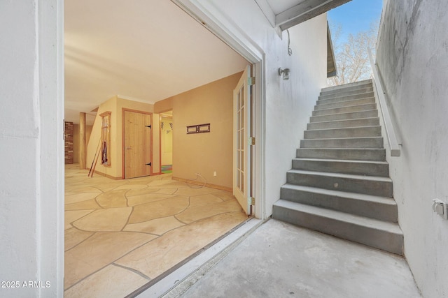 stairway featuring concrete floors