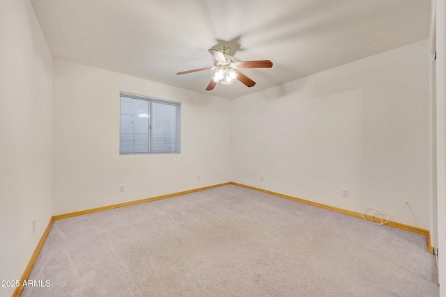 empty room with ceiling fan and light carpet