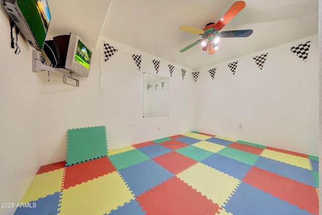 interior space with ceiling fan