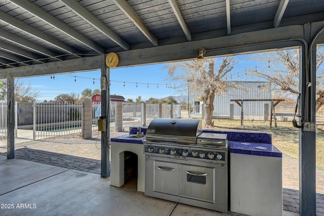 view of patio / terrace featuring an outdoor kitchen and a grill