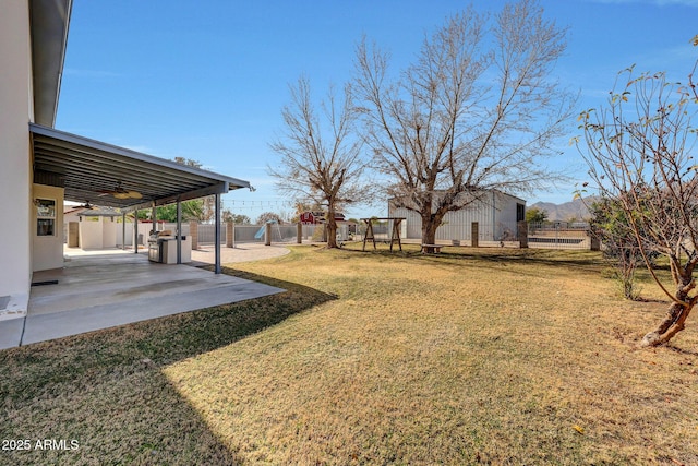 view of yard with a patio and ceiling fan