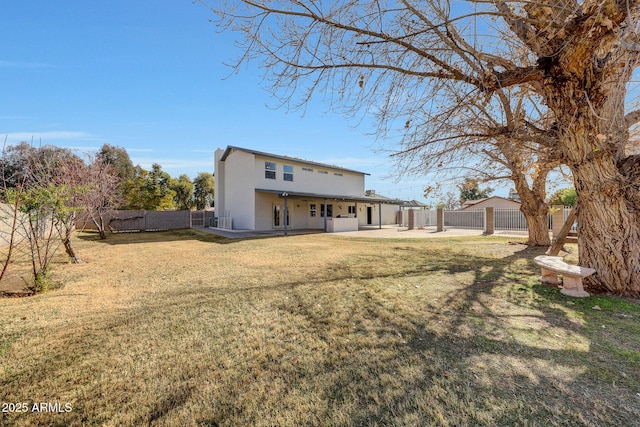 rear view of property with a patio and a yard