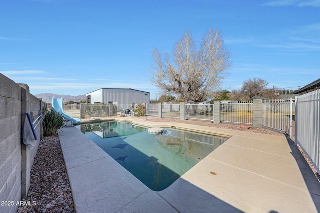 view of pool with a patio and a water slide