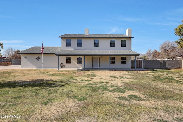 back of property featuring a yard and a patio