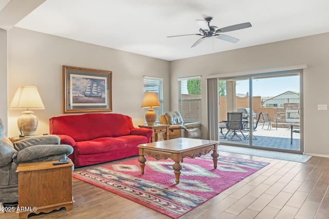 living room with hardwood / wood-style floors and ceiling fan