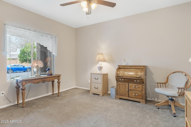 living area with light carpet and ceiling fan