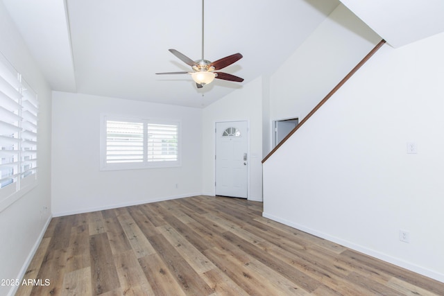 222 W Brown Rd Unit 72, Mesa, AZ 85201 - unfurnished living room with a ceiling fan, wood finished floors, lofted ceiling, baseboards, and stairs