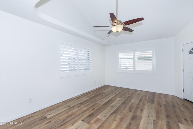 222 W Brown Rd Unit 72, Mesa, AZ 85201 - empty room with wood finished floors, a ceiling fan, baseboards, and a raised ceiling