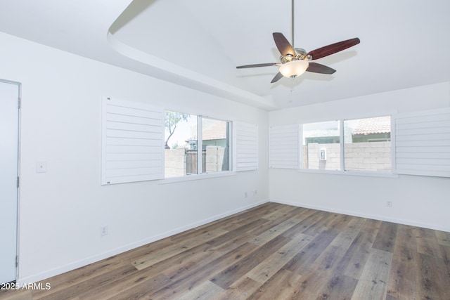 222 W Brown Rd Unit 72, Mesa, AZ 85201 - spare room with wood finished floors, ceiling fan, baseboards, and a raised ceiling