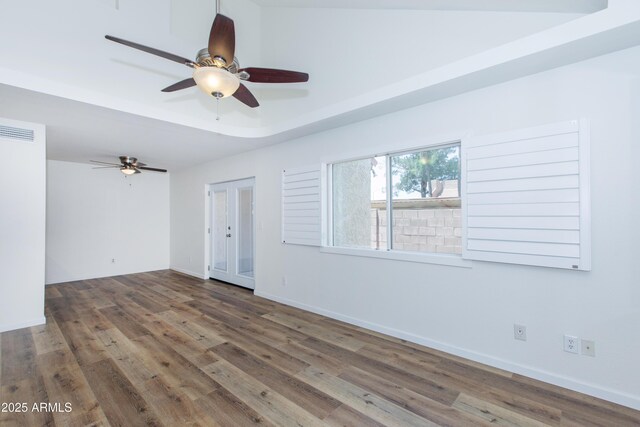 222 W Brown Rd Unit 72, Mesa, AZ 85201 - spare room featuring ceiling fan, wood finished floors, baseboards, and a raised ceiling