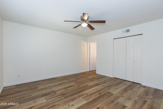 222 W Brown Rd Unit 72, Mesa, AZ 85201 - unfurnished bedroom featuring wood finished floors, baseboards, a closet, and a ceiling fan