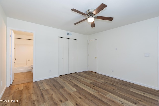 222 W Brown Rd Unit 72, Mesa, AZ 85201 - unfurnished bedroom with wood finished floors, baseboards, a closet, and connected bathroom