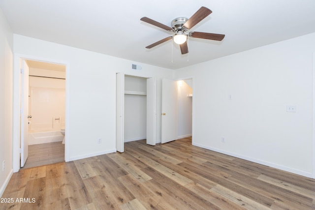 222 W Brown Rd Unit 72, Mesa, AZ 85201 - unfurnished bedroom with light wood-style flooring, connected bathroom, baseboards, and ceiling fan