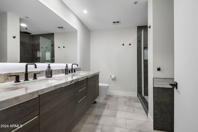 bathroom featuring vanity, tile patterned flooring, toilet, and walk in shower