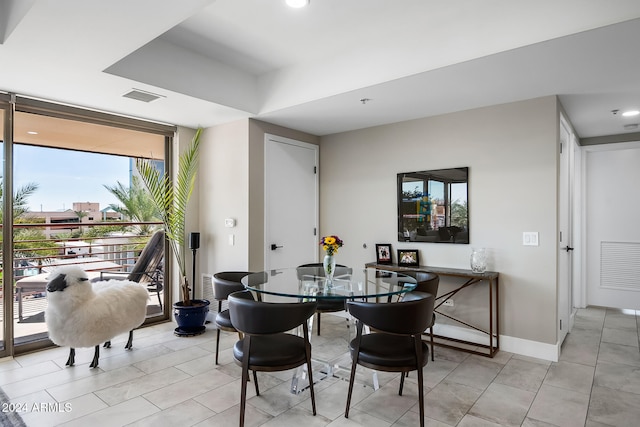 tiled dining area featuring plenty of natural light