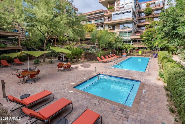 view of pool featuring a patio and a community hot tub