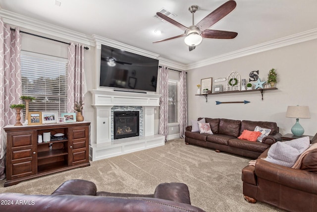 carpeted living room featuring ornamental molding and ceiling fan