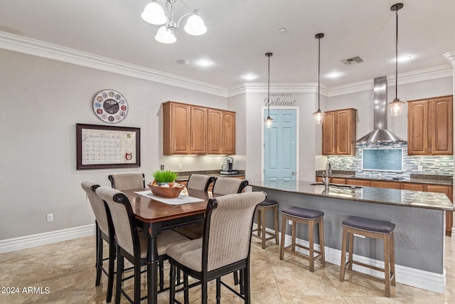 dining area with ornamental molding and a chandelier