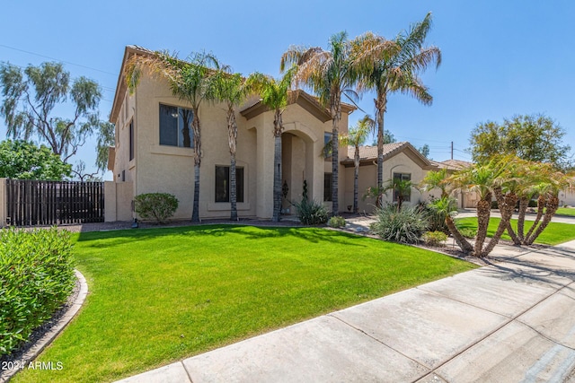 mediterranean / spanish house with a front yard