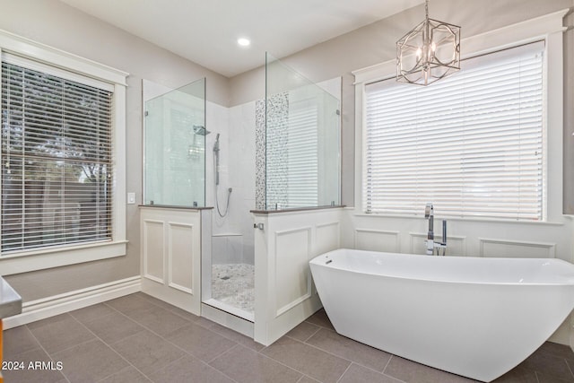 bathroom with independent shower and bath, tile patterned flooring, and a notable chandelier