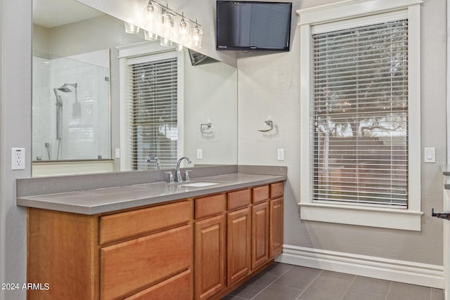 bathroom featuring walk in shower, vanity, and tile patterned flooring