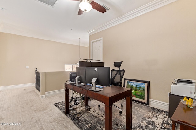 carpeted home office featuring crown molding and ceiling fan