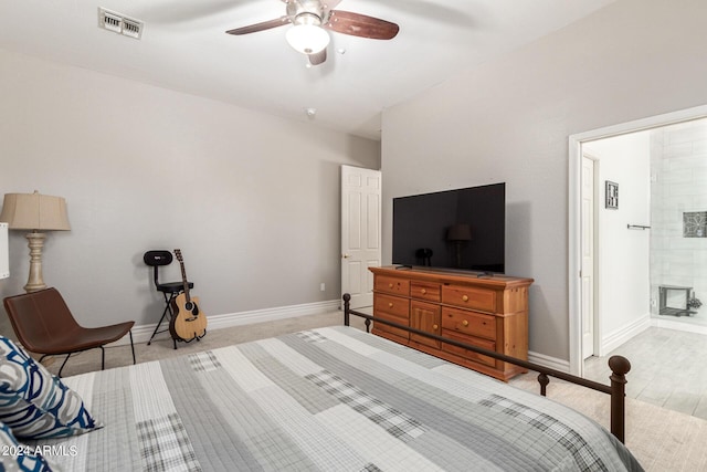 bedroom featuring ensuite bath, a fireplace, and ceiling fan