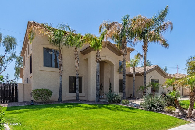 mediterranean / spanish-style house featuring a front lawn