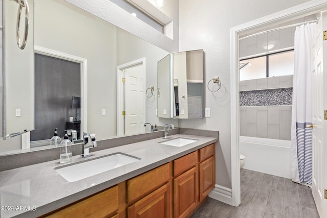 full bathroom with shower / bath combo, wood-type flooring, vanity, and toilet