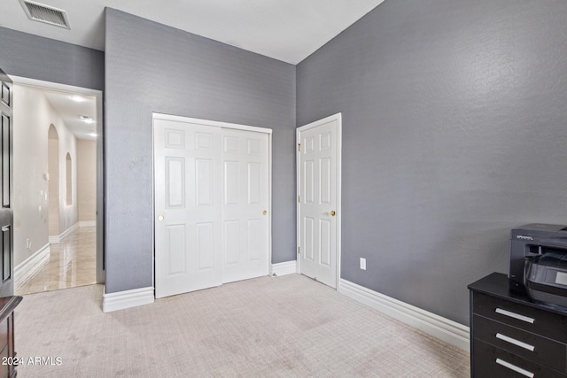 carpeted bedroom featuring a closet