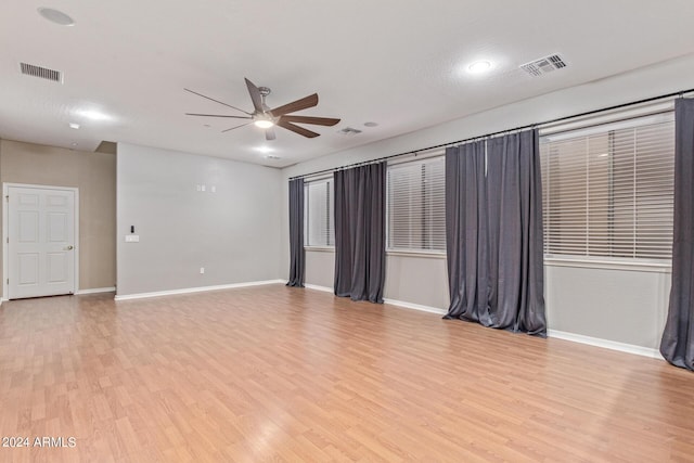 spare room featuring ceiling fan and light hardwood / wood-style flooring