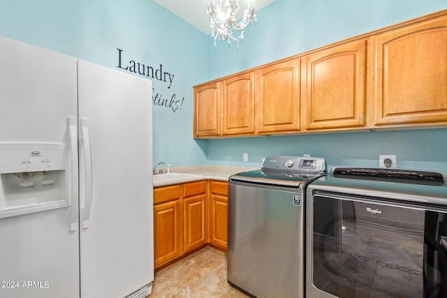 laundry room featuring cabinets, separate washer and dryer, sink, and a chandelier