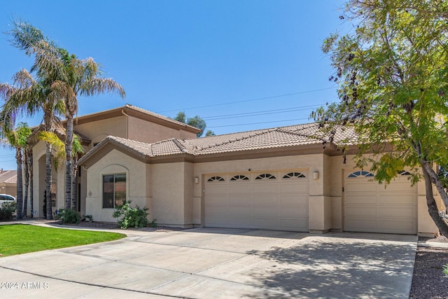 mediterranean / spanish-style home with a garage