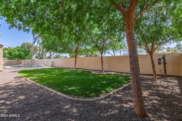 view of yard with a fenced in pool