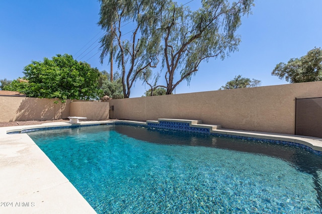 view of pool featuring a diving board