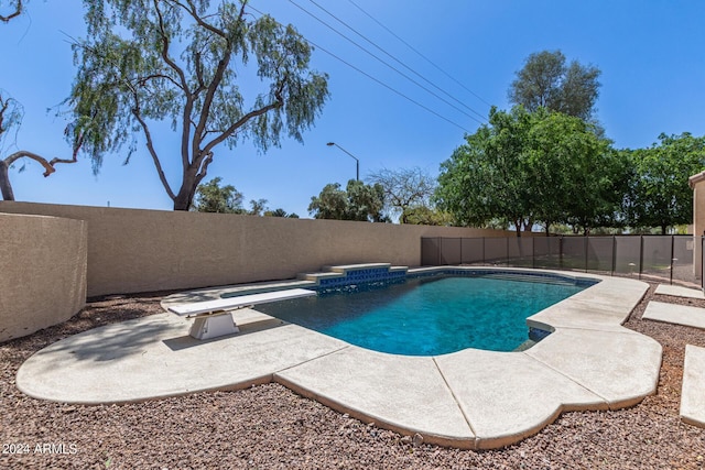 view of pool featuring a patio and a diving board