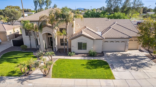 view of front of property with a garage and a front yard