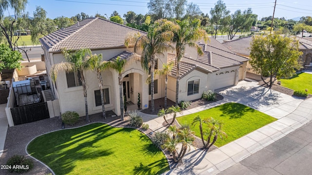 mediterranean / spanish-style house with a garage and a front yard