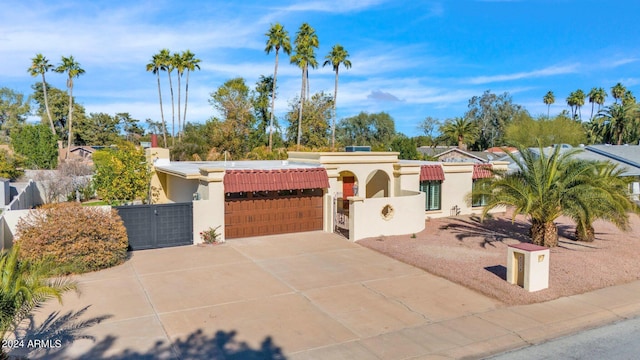 view of front of house featuring a fenced front yard, a gate, and stucco siding