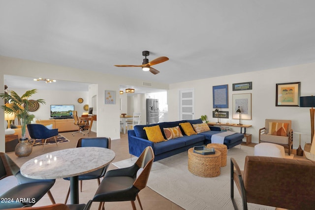 living room with visible vents and ceiling fan with notable chandelier